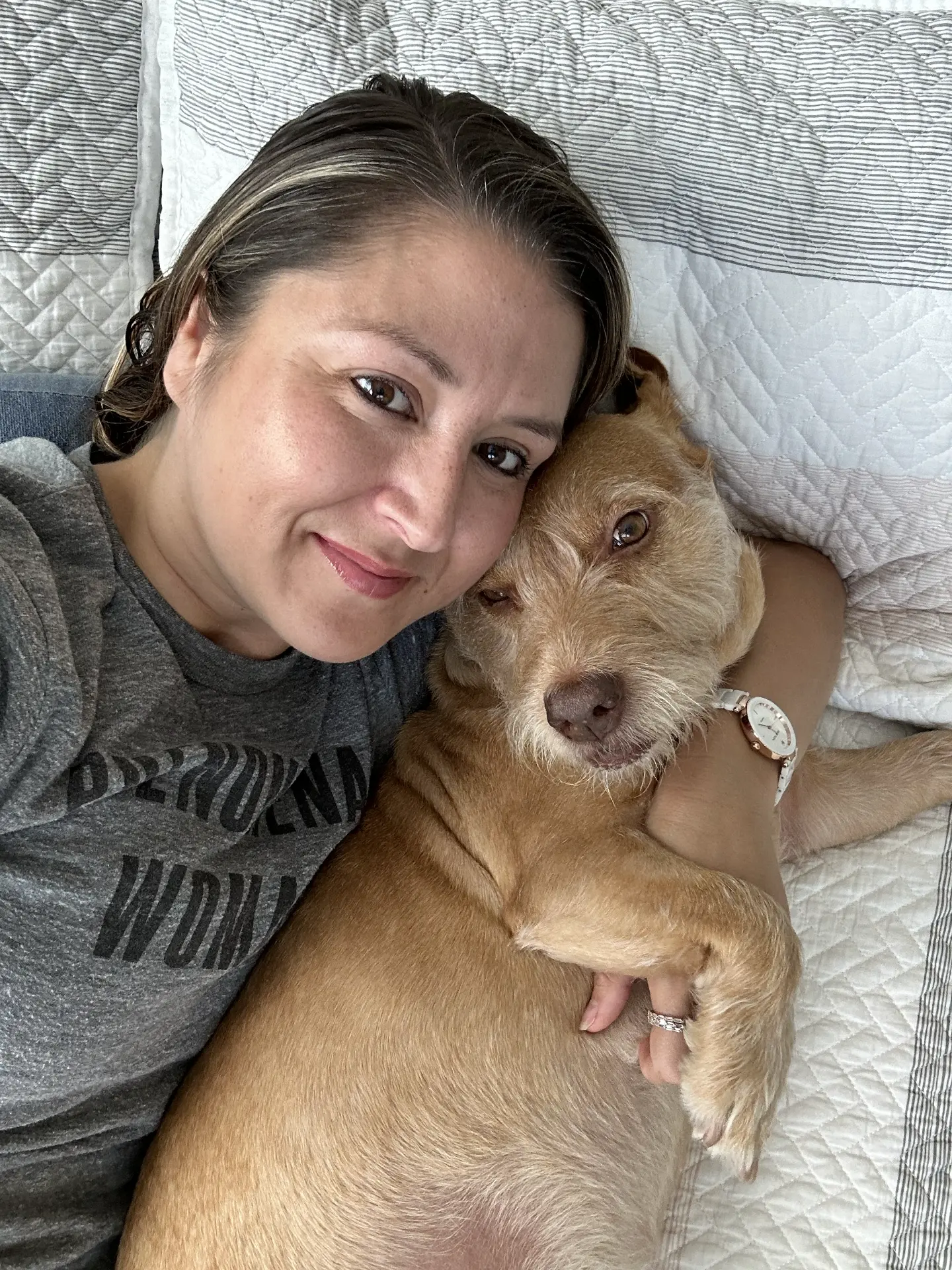 The human behind WagPack cuddling her pup Pixie